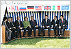 G-8 Leaders Seated on Bench With Flags Overhead