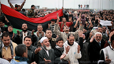 File Photo of Crowd of Libyan Protesters, Some with Large Flag