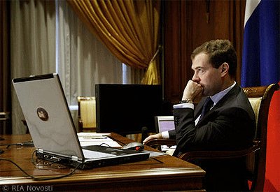 File Photo of Dmitri Medvedev Sitting at Desk with Laptop Computer and Hand to Chin