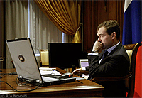 File Photo of Dmitry Medvedev with Laptop at Desk, With Hand to Chin