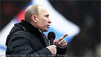 File Photo of Vladimir Putin at Outdoor Rally in Heavy Coat with Microphone