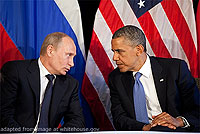 File Photo of Vladimir Putin and Barack Hussein Obama II Sitting and Leaning Towards Each Other with Russian and U.S. Flags Behind Them