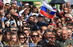 File Photo of Crowd of Russians, Including One Waving Flag