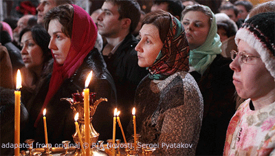 File Photo of Russian Orthodox Faithful Holding Candles at Christmas