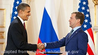 Barack Hussein Obama II and Dmitry Medvedev Shaking Hands in Front of Russian and American Flags in File Photo